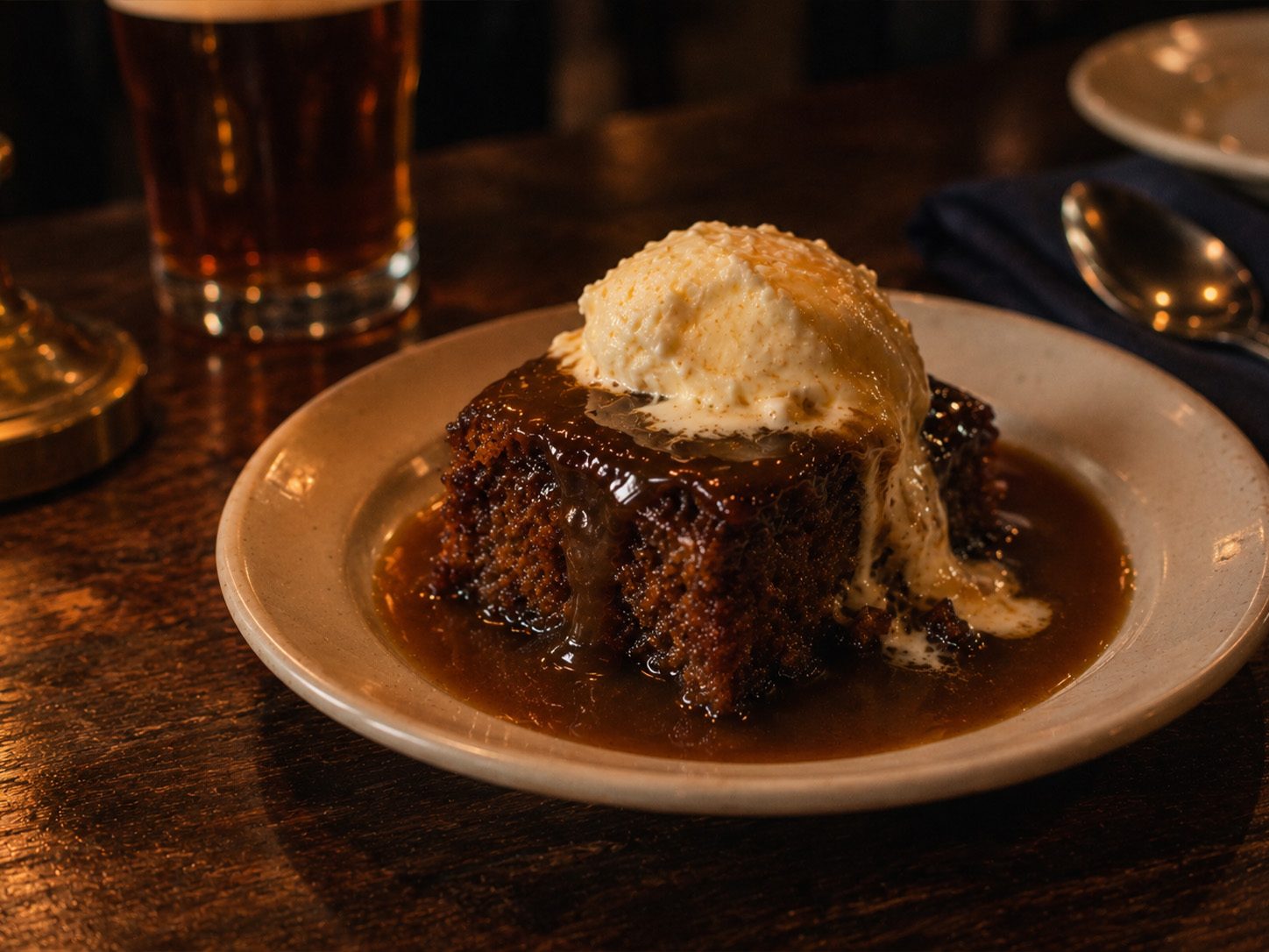 Concept image, generated: sticky toffee pudding with toffee sauce and clotted cream